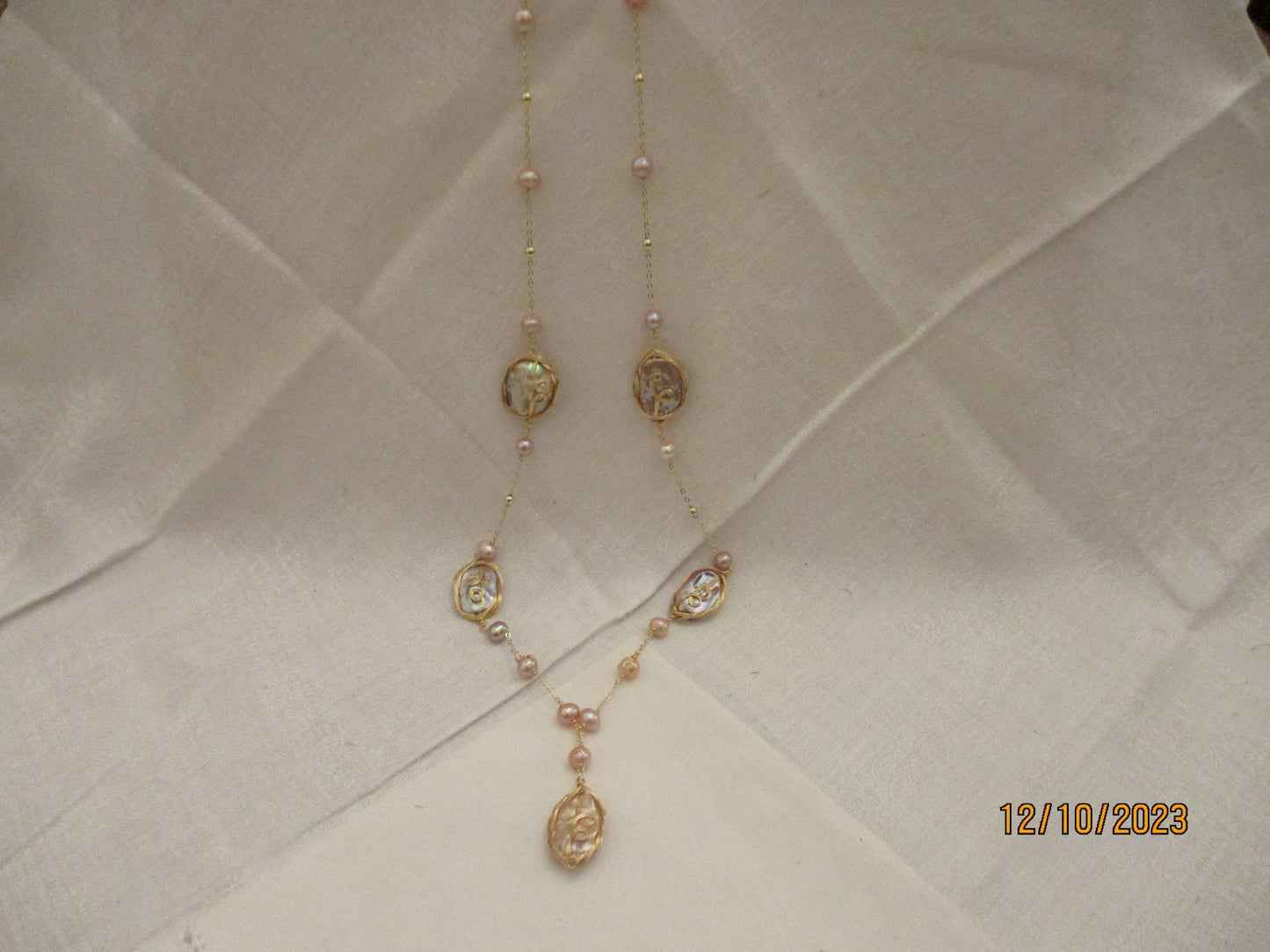 A Long Pearl and Mother of Pearl Necklace.