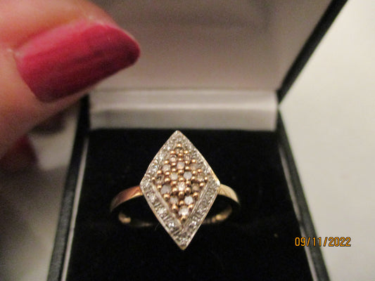 A Gold  Cinnamon and White Dimond Ring .